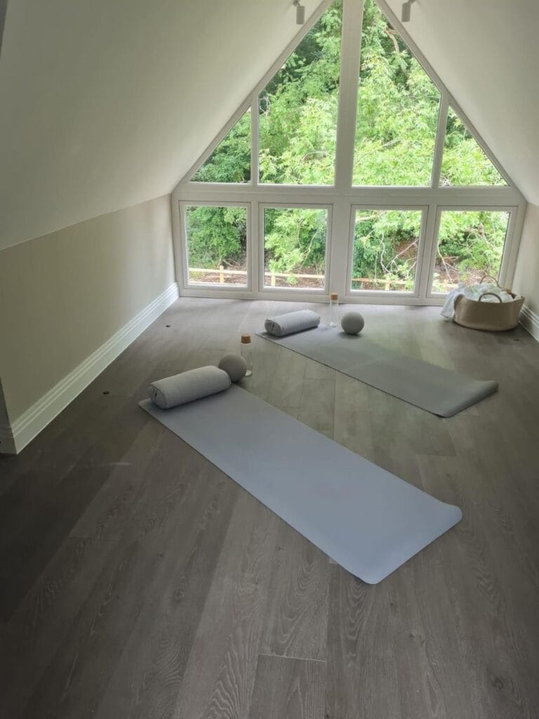 Converted Loft Yoga Room with Skylight Windows and Minimalist Flooring