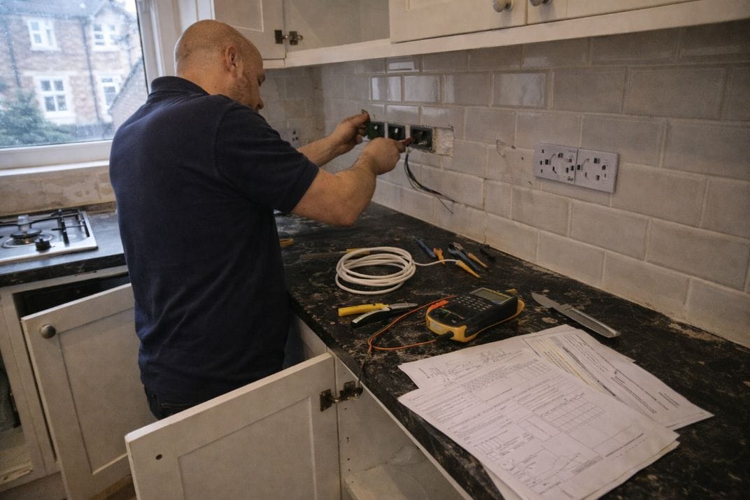 an illustrative image of a trademens carrying out electrical work